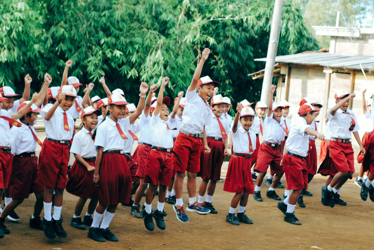 Students celebrating together in school uniform